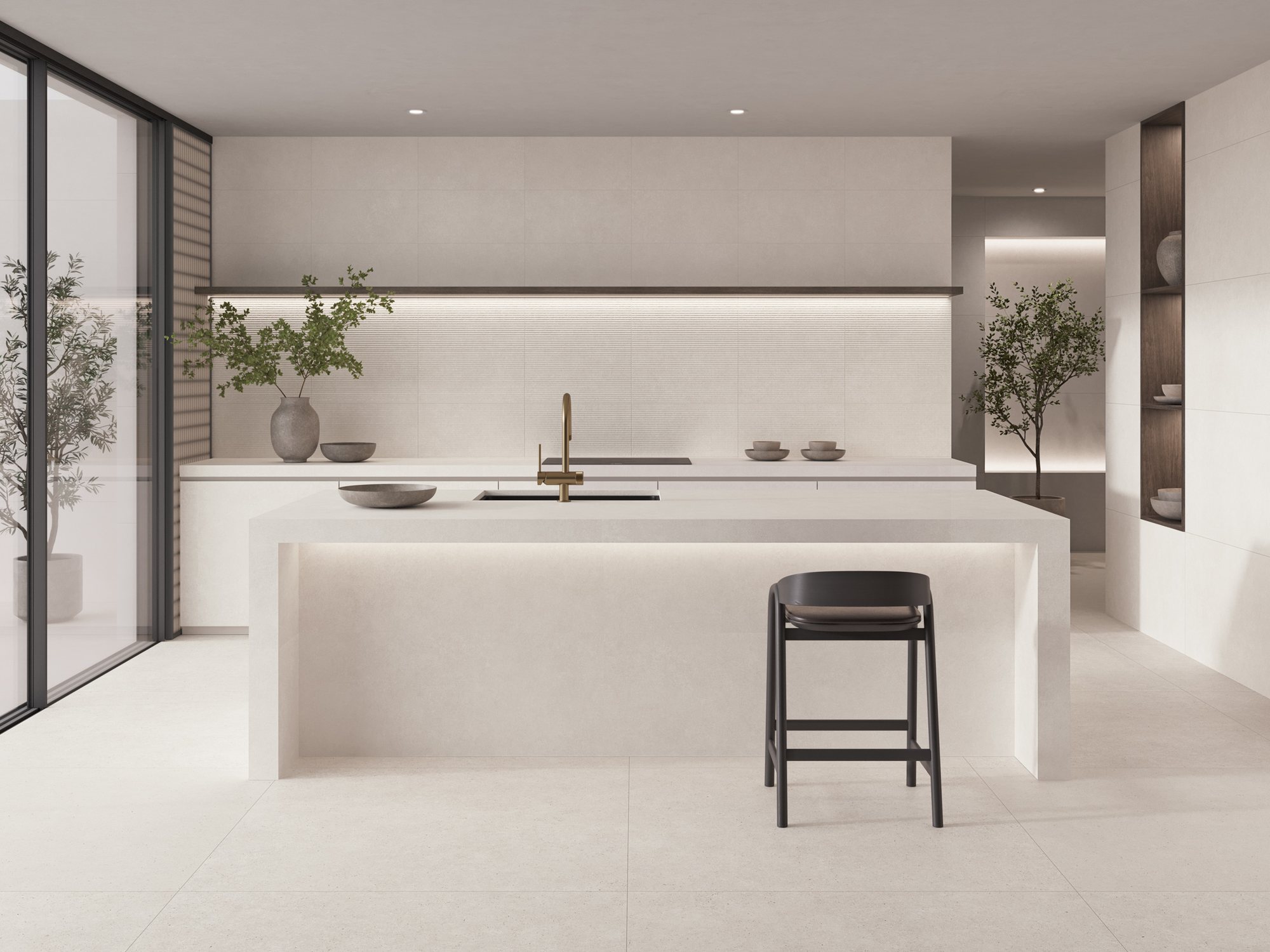 Kitchen with a stone-effect island, integrated lighting and floor-to-ceiling garden windows
