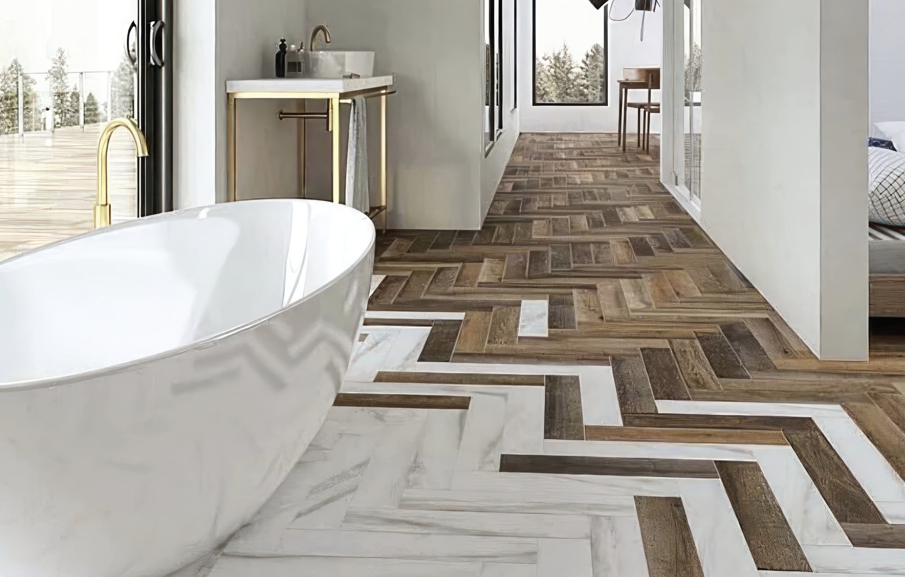 Freestanding bath on a herringbone floor of wood-effect and marble-effect tiles