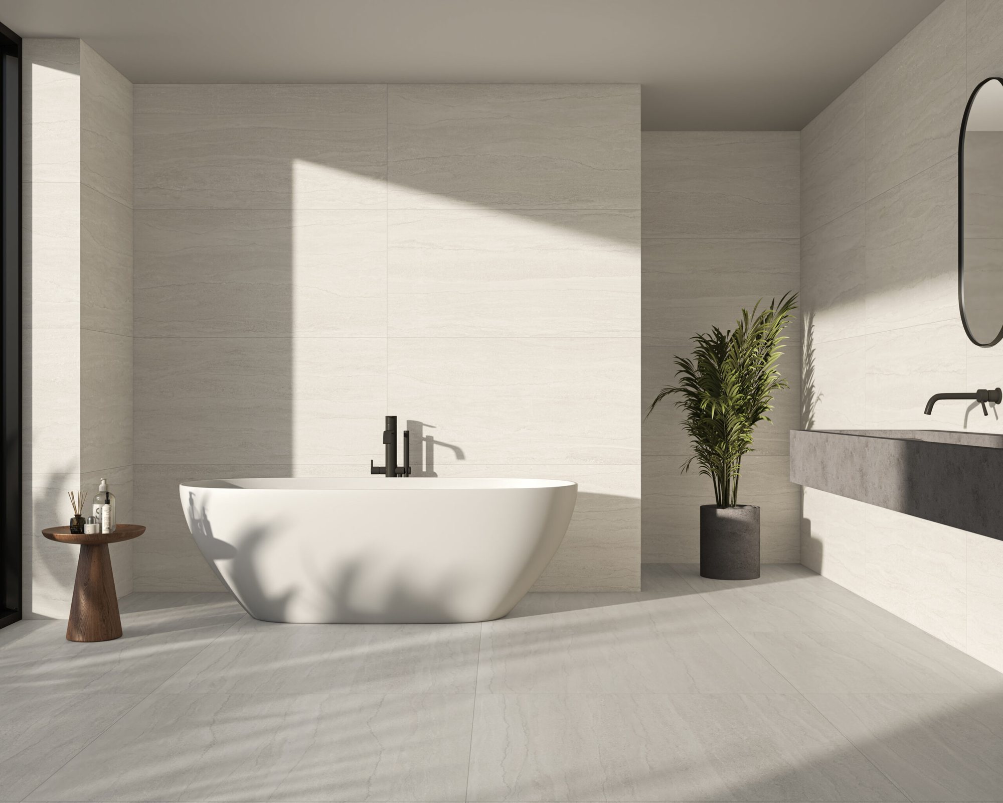 Bathroom in soft pearl large-format tiles, with a freestanding bath and a wall-hung stone basin