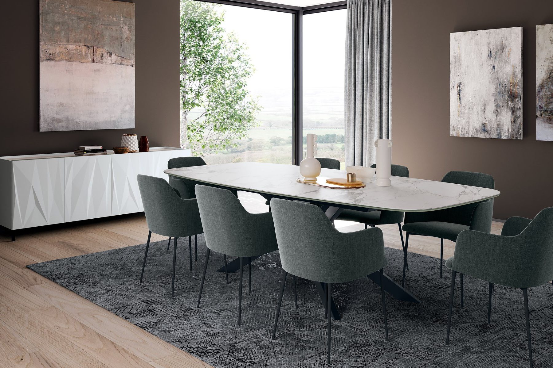 Dining room with an oval table and green upholstered chairs by a corner window